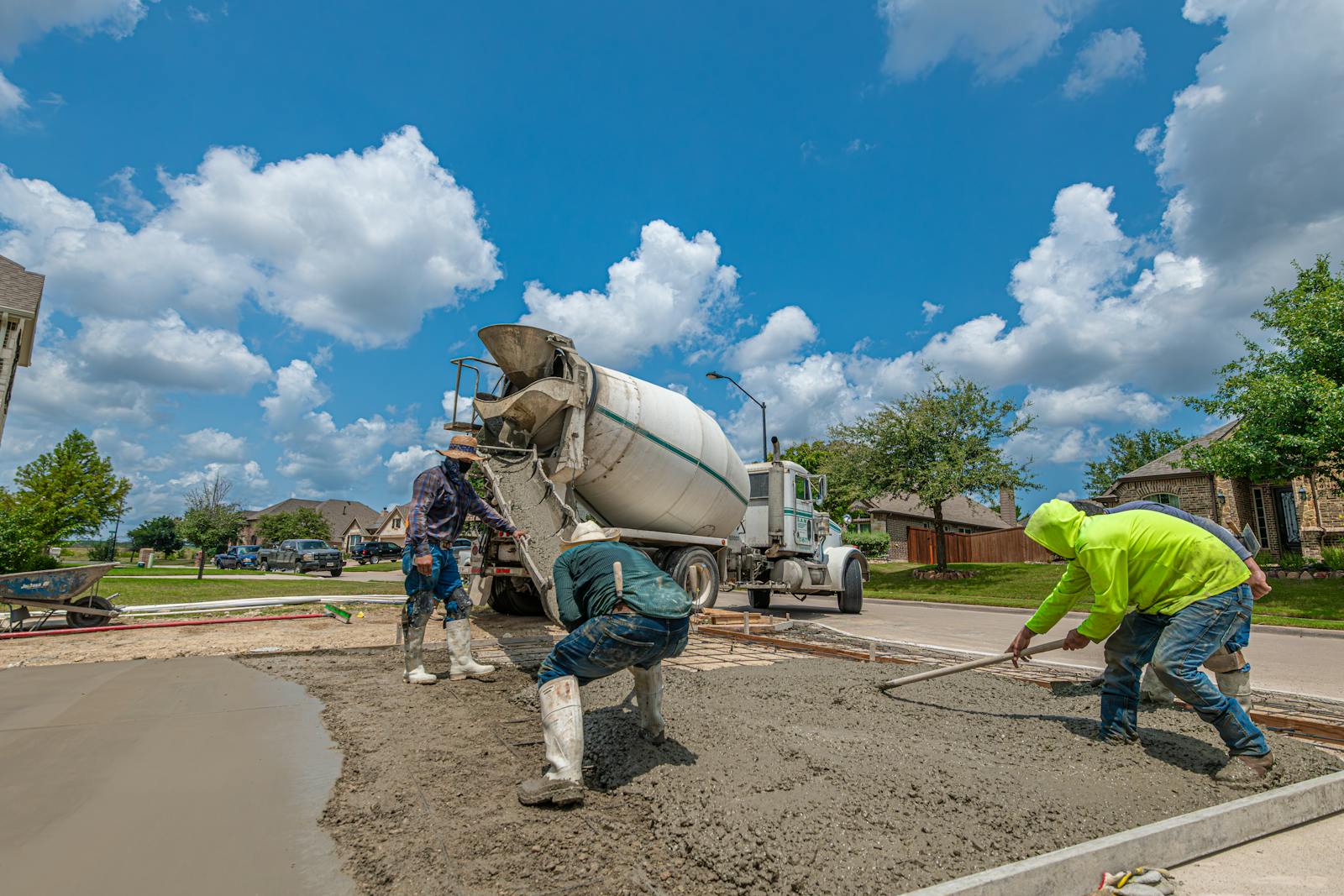 Ready-mix truck pouring a residential concrete driveway